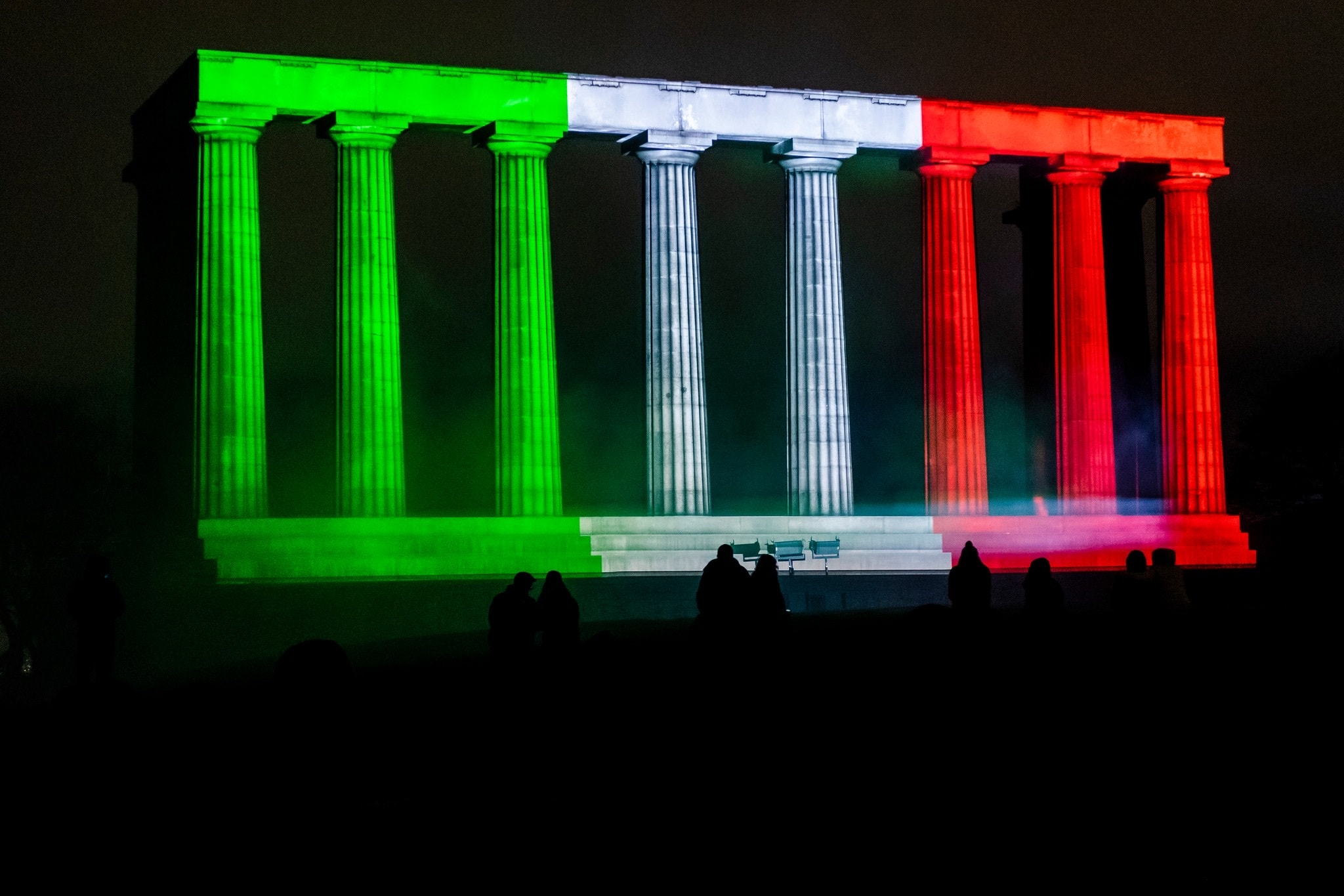 The National Monument on Calton Hill lit in the Italian tricolour